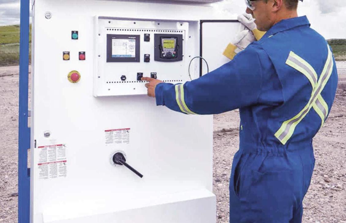 Schlumberger employees reads metering equipment in the field.