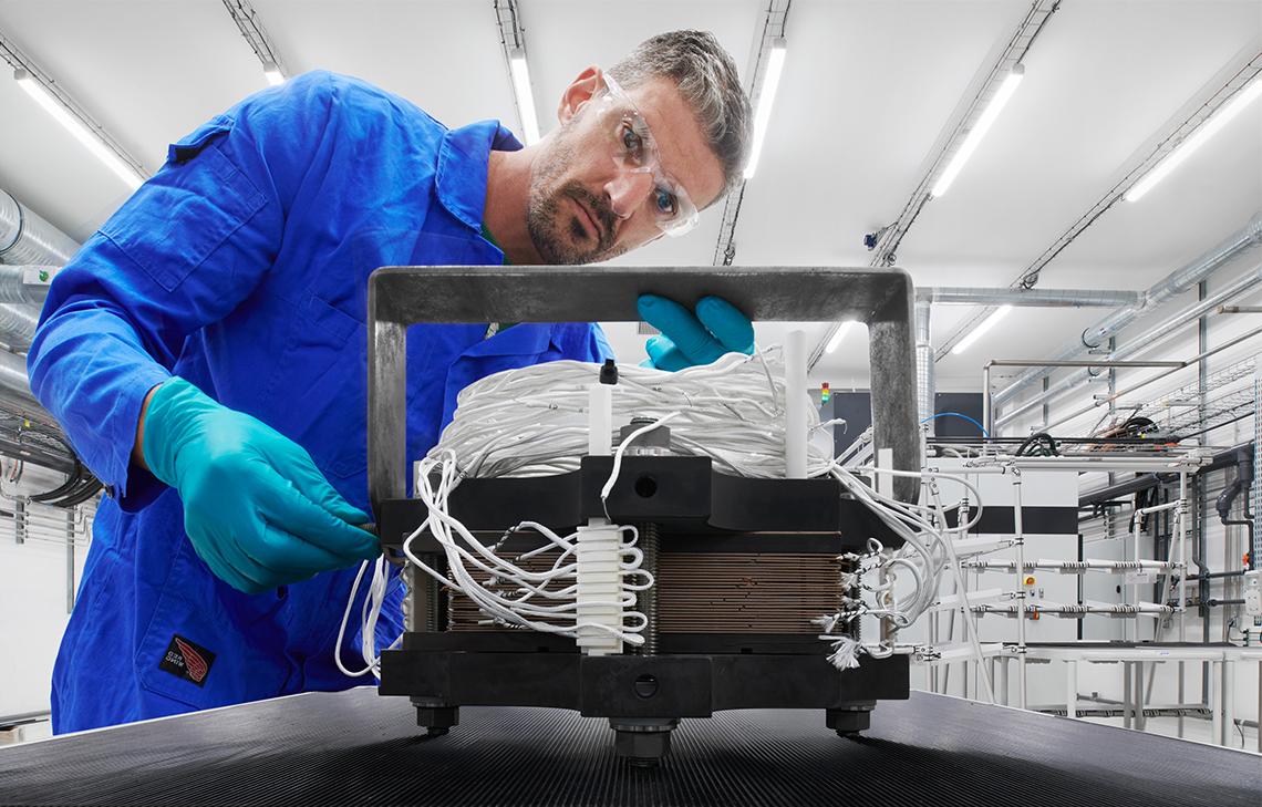 Engineer looking at a piece of an equipment in a manufacturing facility, Beziers. (Tier 1_ManufacturingFacility_Beziers_OAT_ 15212)